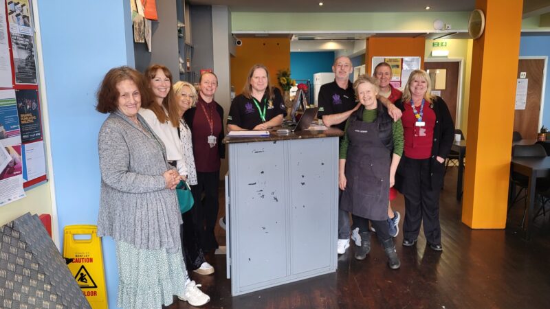 Group image of Sanctus and clinic staff with service users