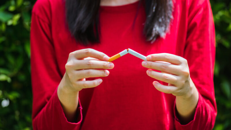 May 31 of World No Tobacco Day, Asian smoker woman use hands breaking down cigarettes, Stop or quit smoking concept